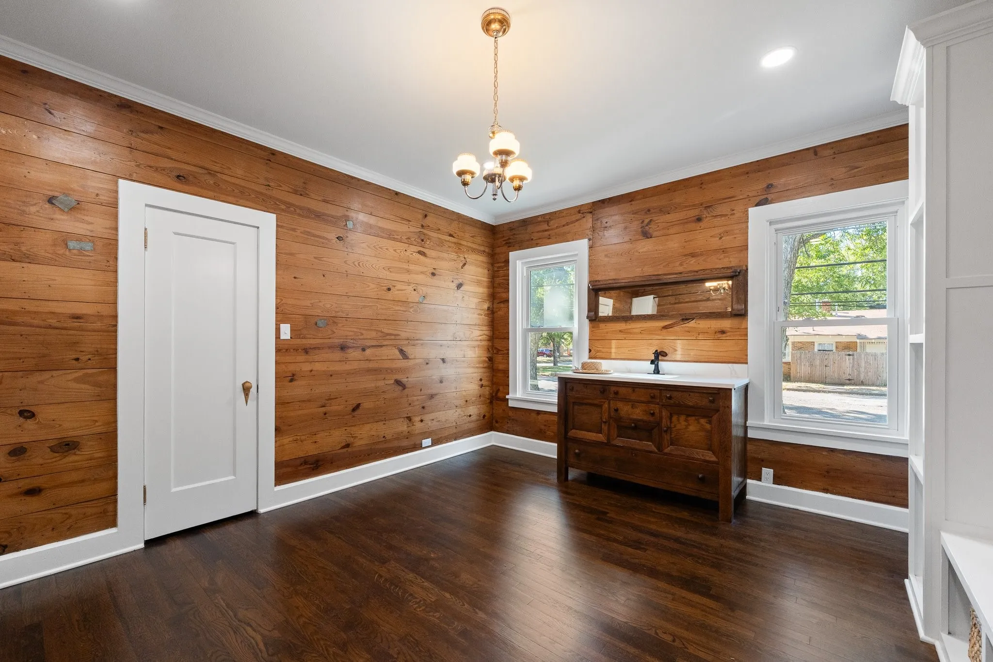 This is actually the HUGE laundry room that doubles as a hobby or craft room. You'll absolutely LOVE this room with its antique sink and original shiplap walls!