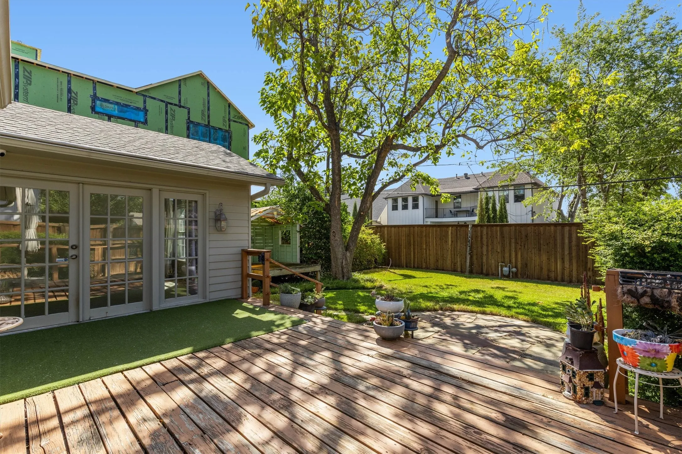 Expansive wooden deck with an integrated artificial turf area