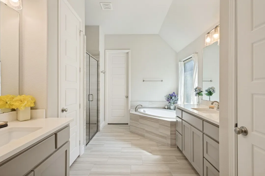 Dual vanity with undermount sinks and light gray cabinetry
