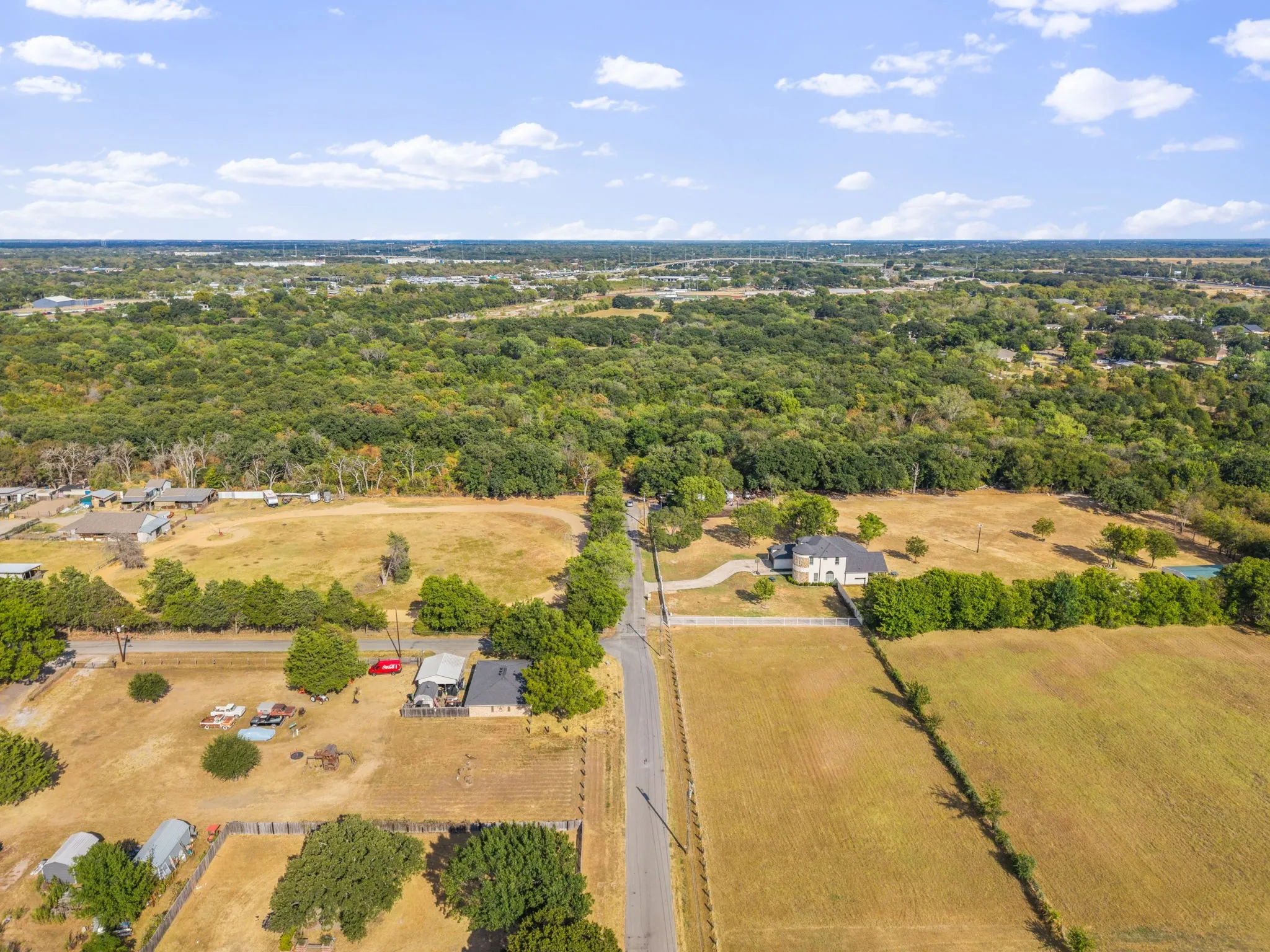 Expansive acreage featuring mature trees and a paved road