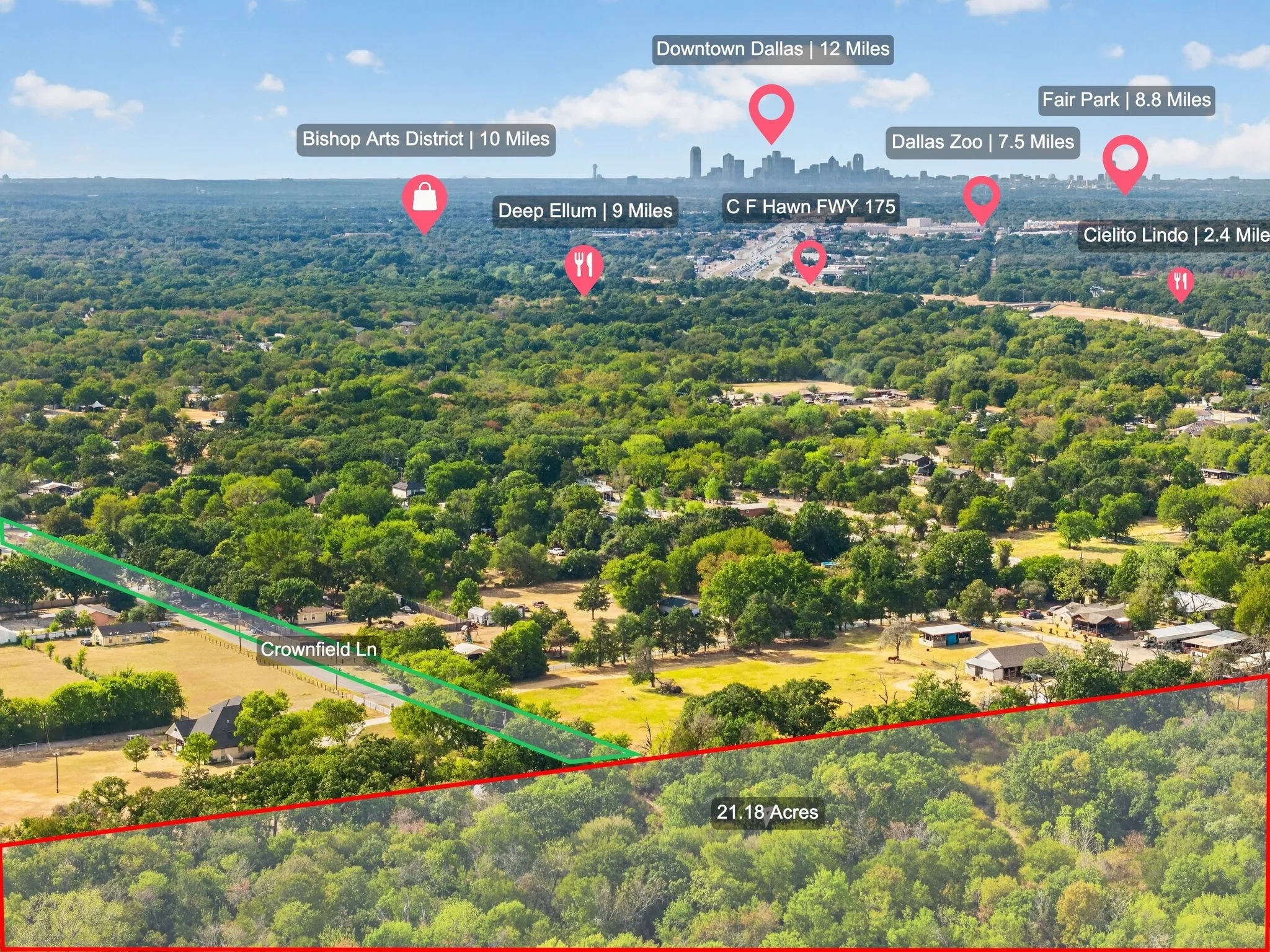 21.18 acres of undeveloped land with mature trees and a distant cityscape