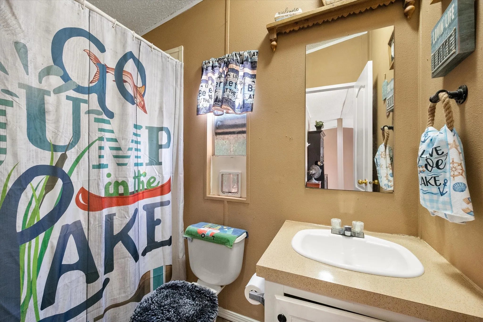 Single vanity with an integrated sink and laminate countertop