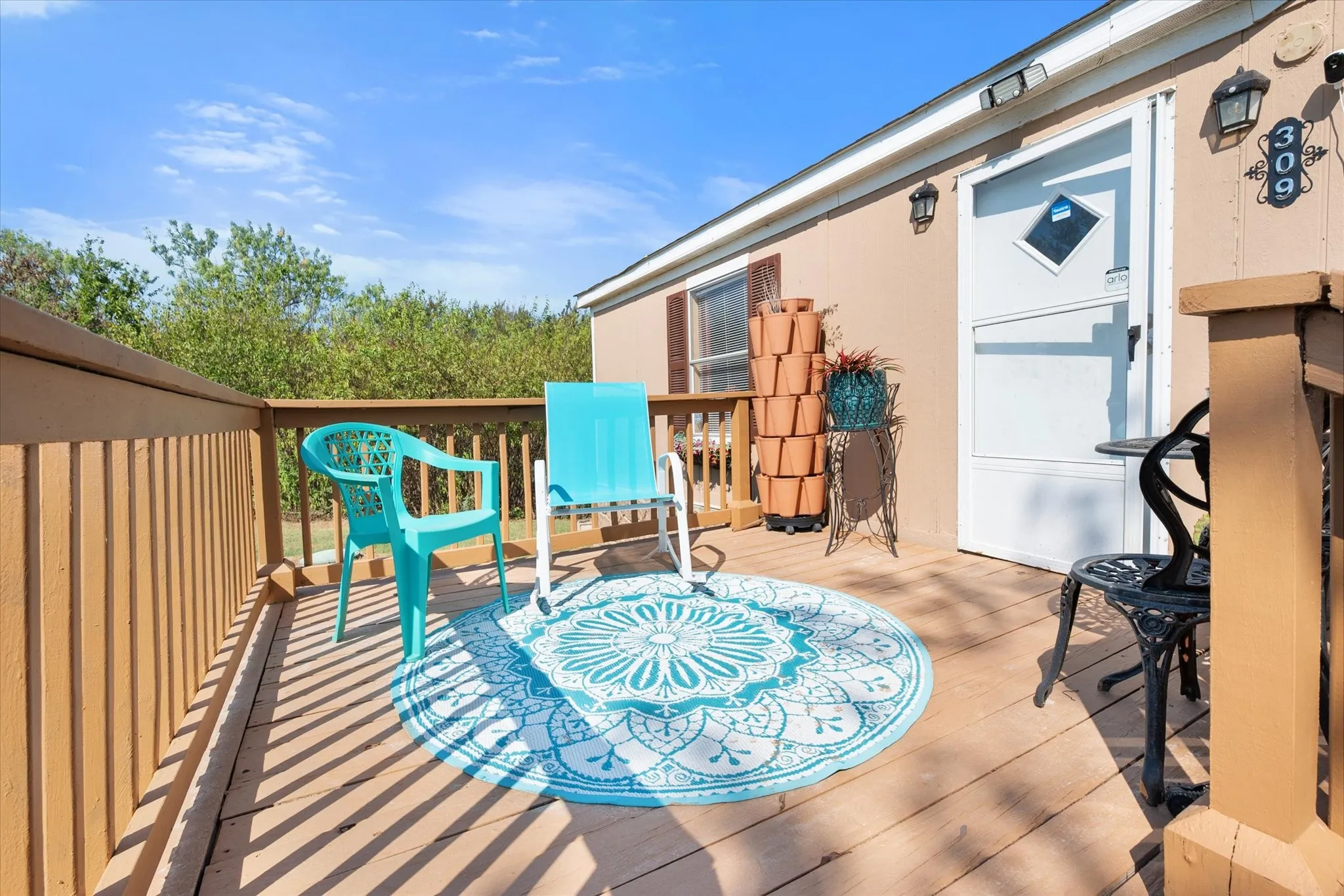 Exterior deck with wood-finish flooring and railing