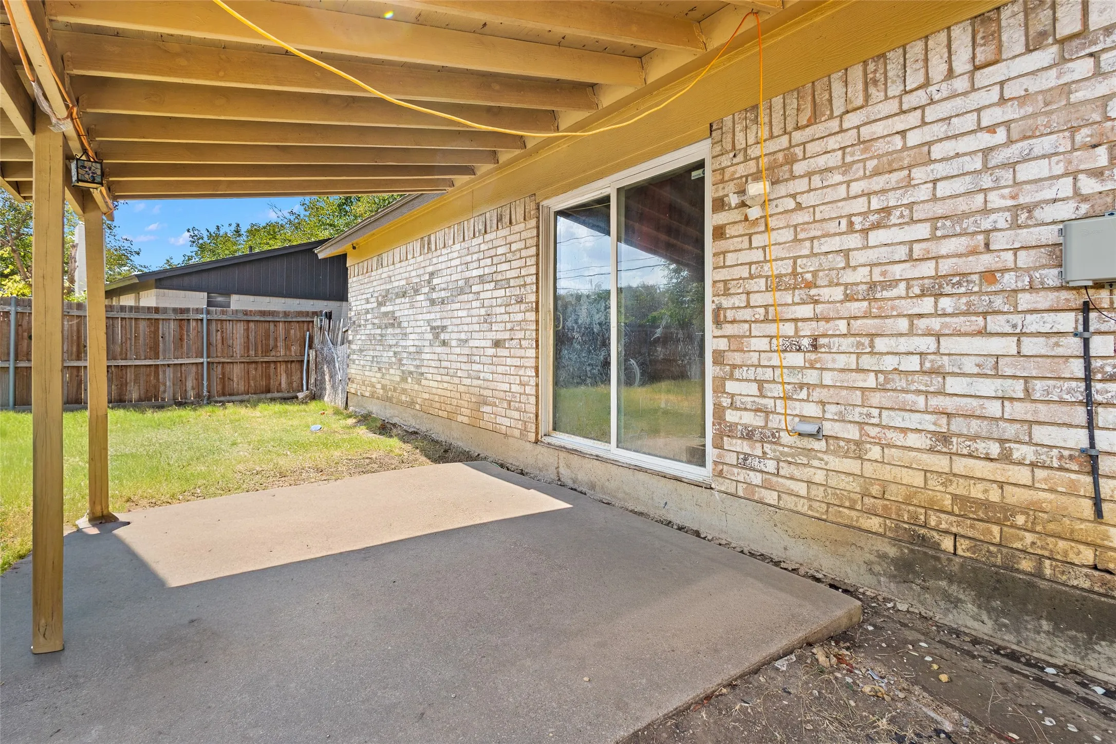 Covered patio featuring a concrete slab and wood beam ceiling
