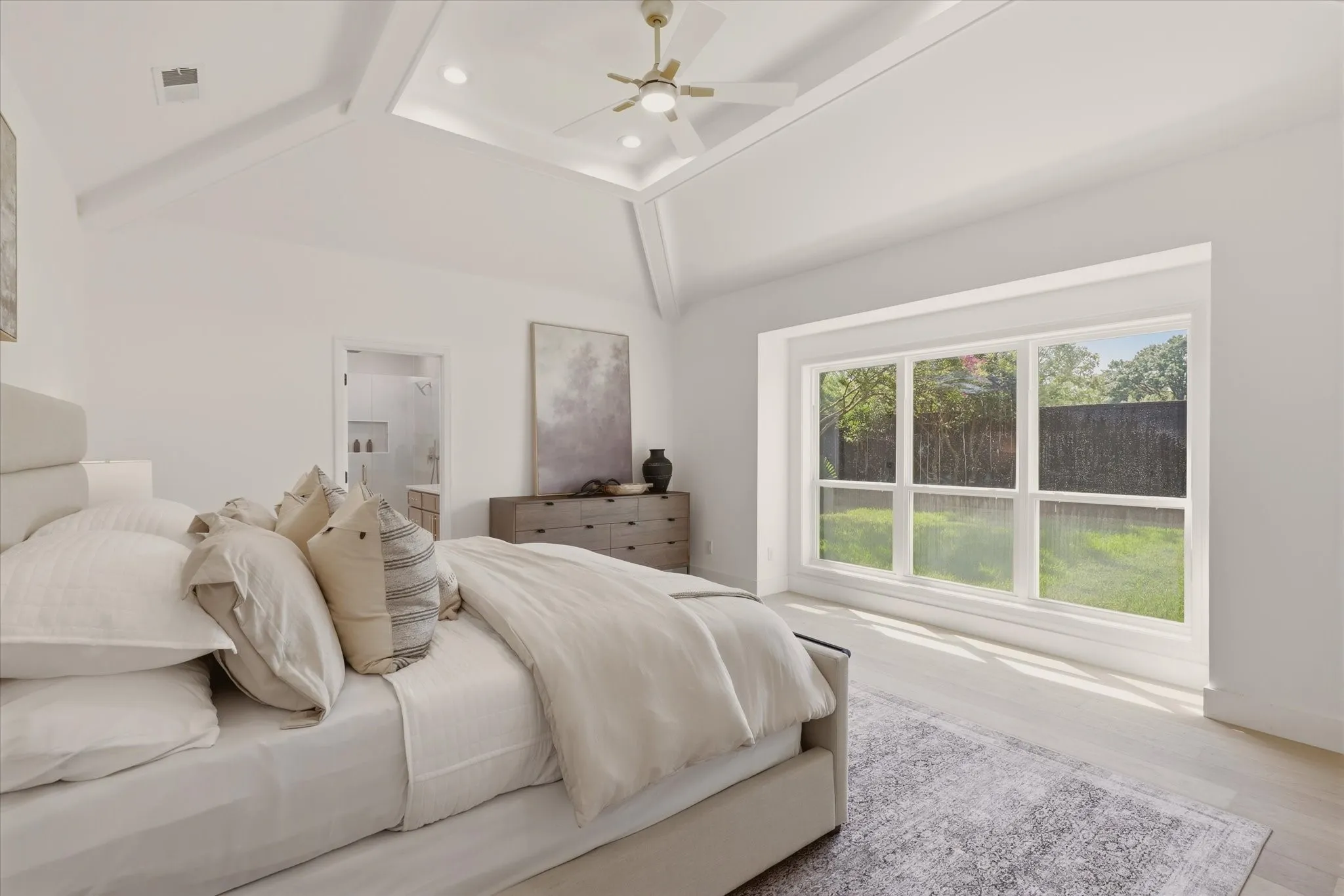 Tray ceiling with recessed lighting, ceiling fan, expansive windows, wood-finish flooring, and a full-light door