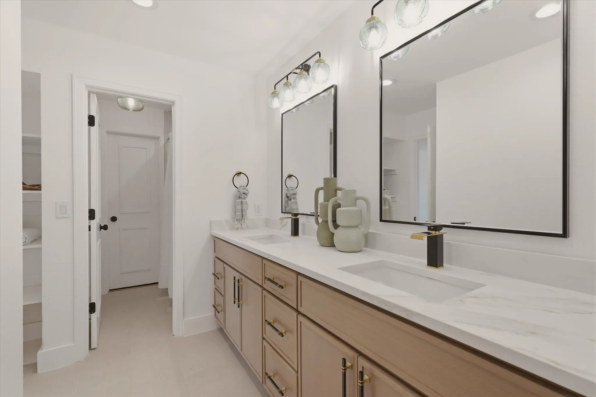 Dual vanity with wood-finish cabinetry, integrated rectangular sinks, and white countertops