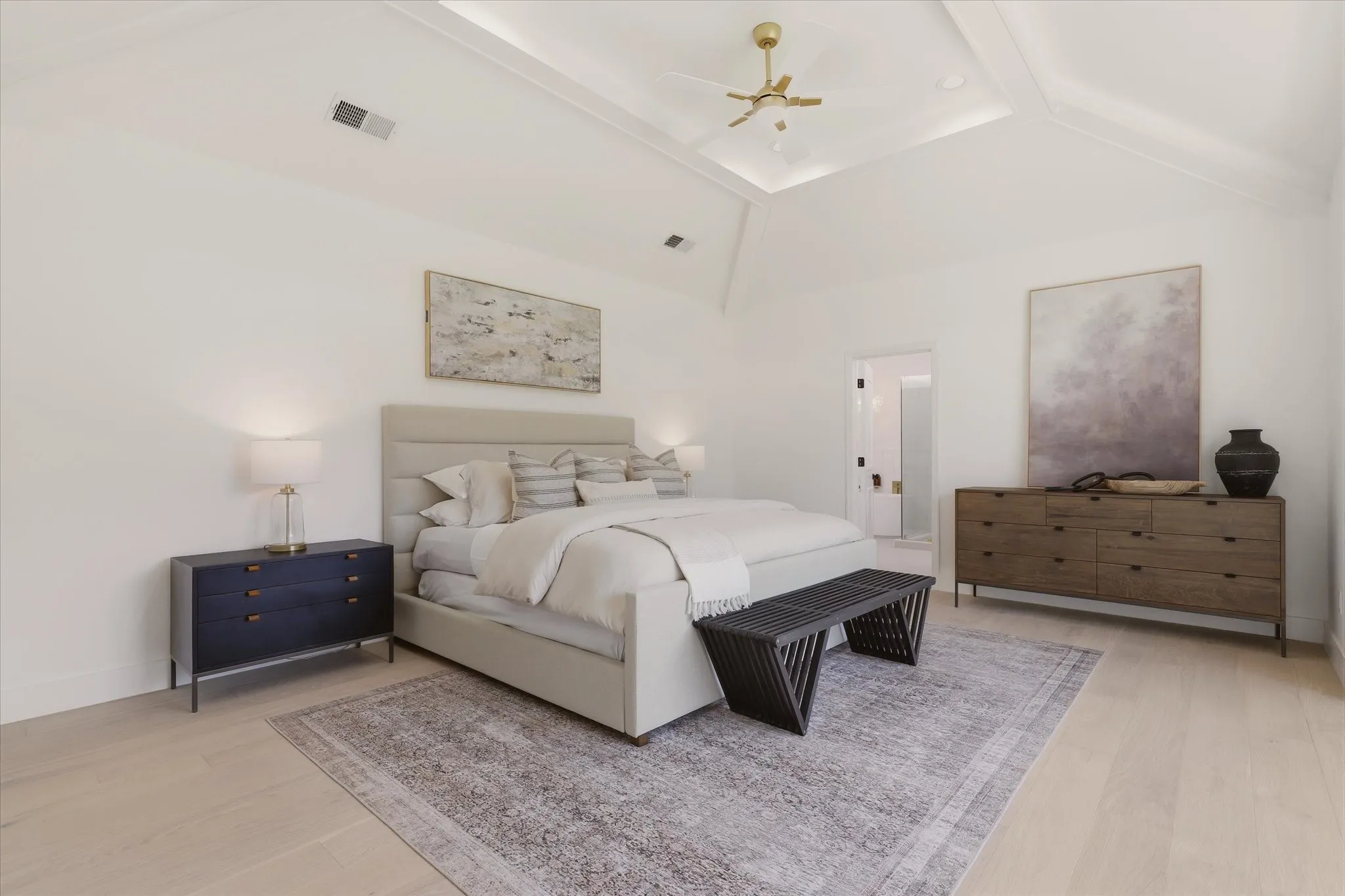 Vaulted ceiling with recessed lighting and a ceiling fan, light wood-finish flooring, and white walls