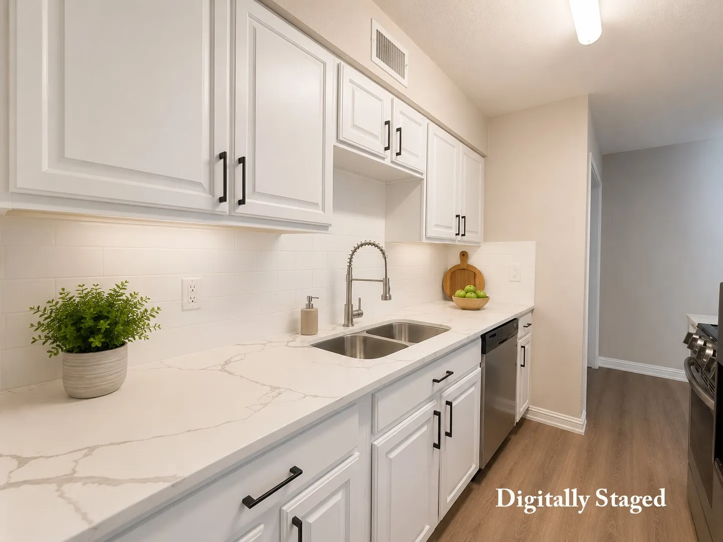 White shaker-style cabinetry with matte black hardware, dual basin stainless steel sink with pull-down faucet, white tiled backsplash, and wood-finish flooring