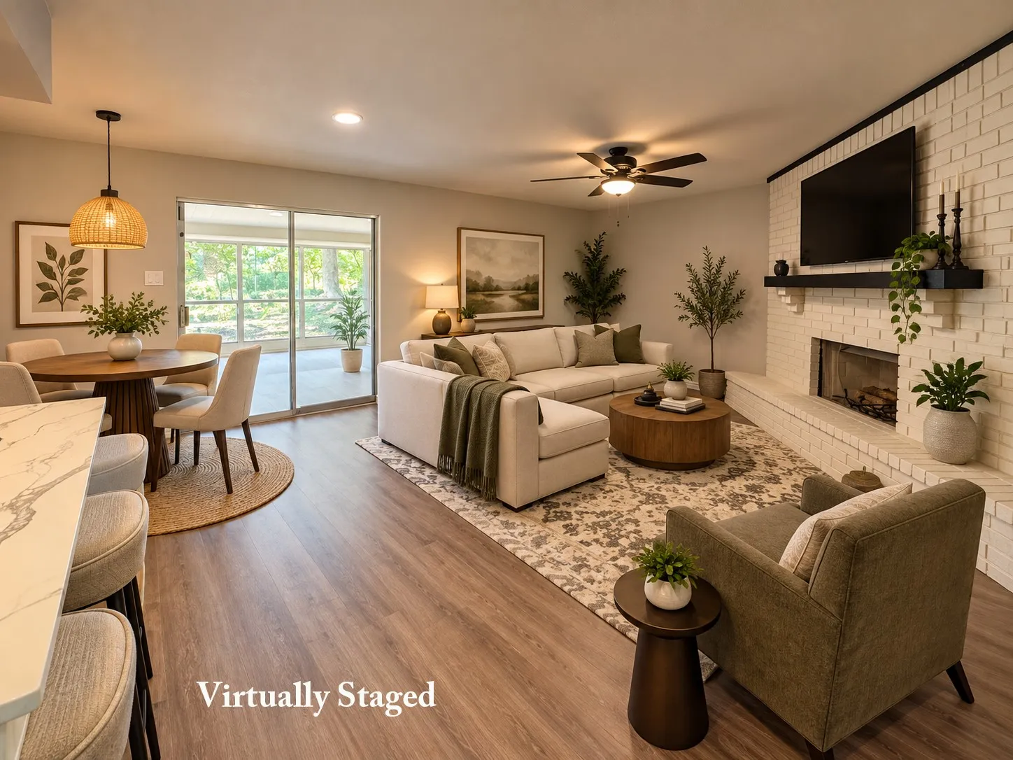 Open-concept living area with wood-finish flooring, a white brick fireplace with a black mantel, and recessed lighting