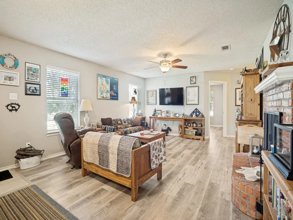 LVP flooring, ceiling fan, wood burning FP