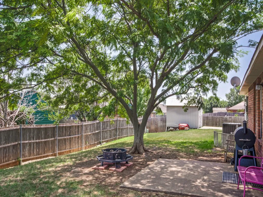 Shade trees and wood fence