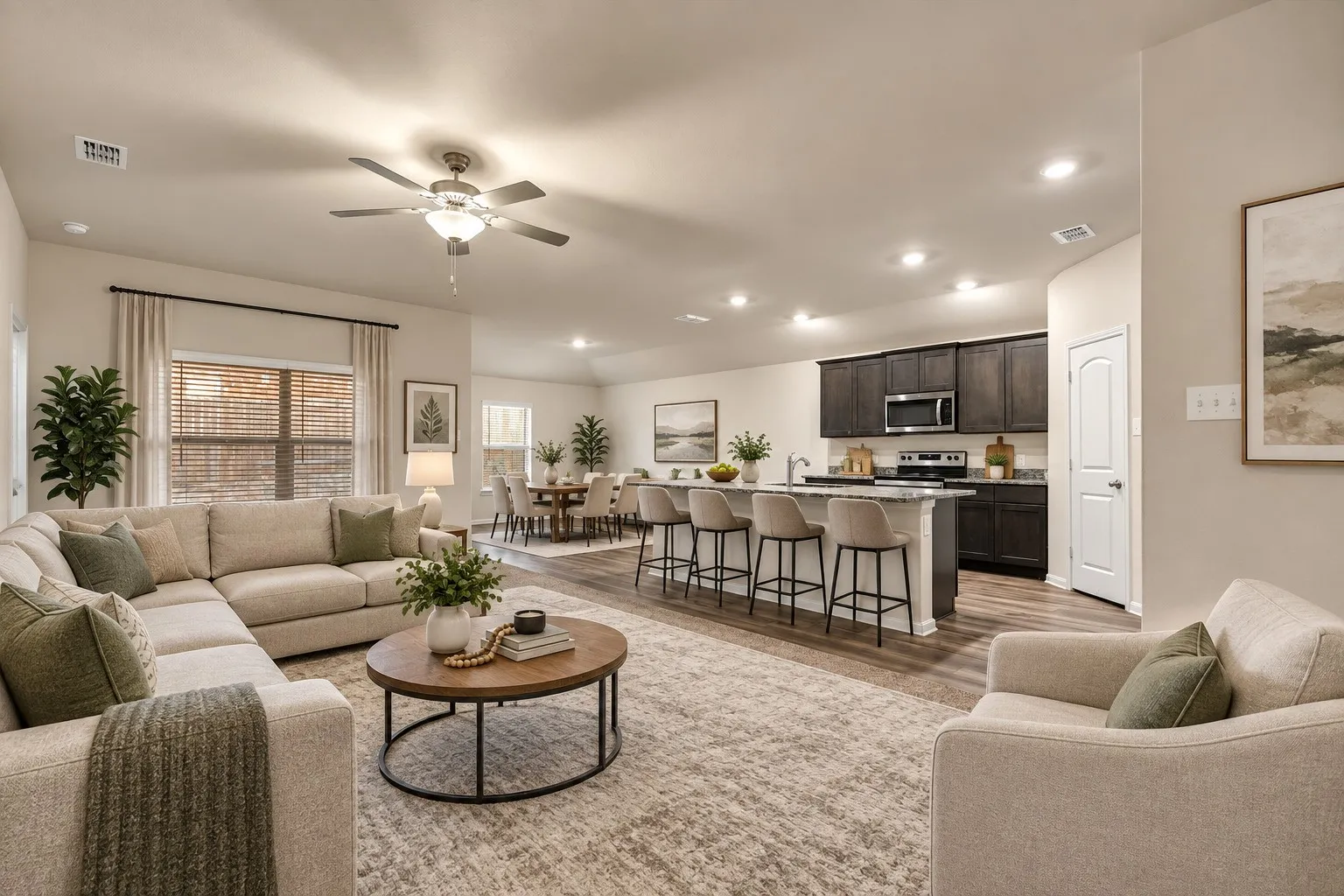 Open-concept living area featuring wood-finish flooring, recessed lighting, and a ceiling fan
