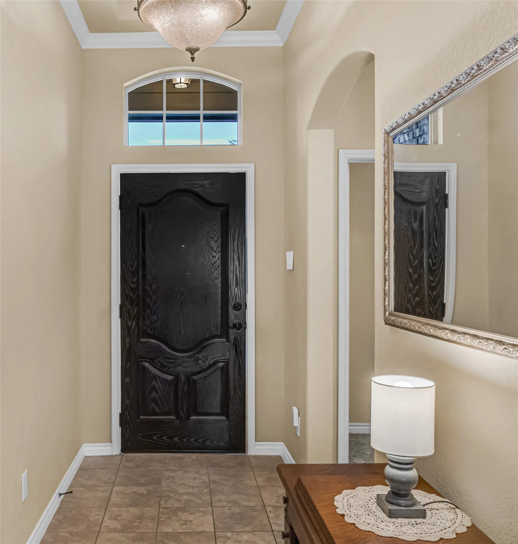 Crown Molding entryway. Looking back at front door with hallway to secondary rooms on the right