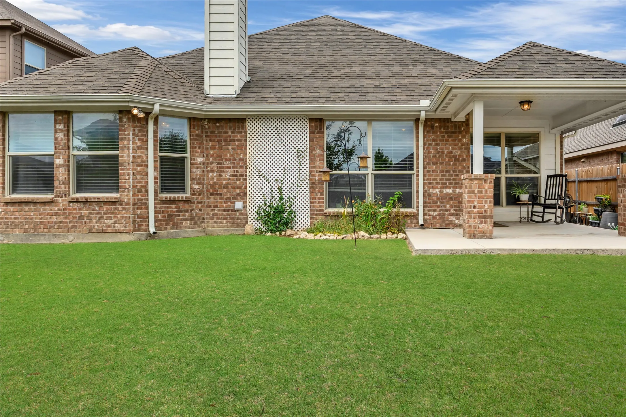 Back yard is well kept with covered patio