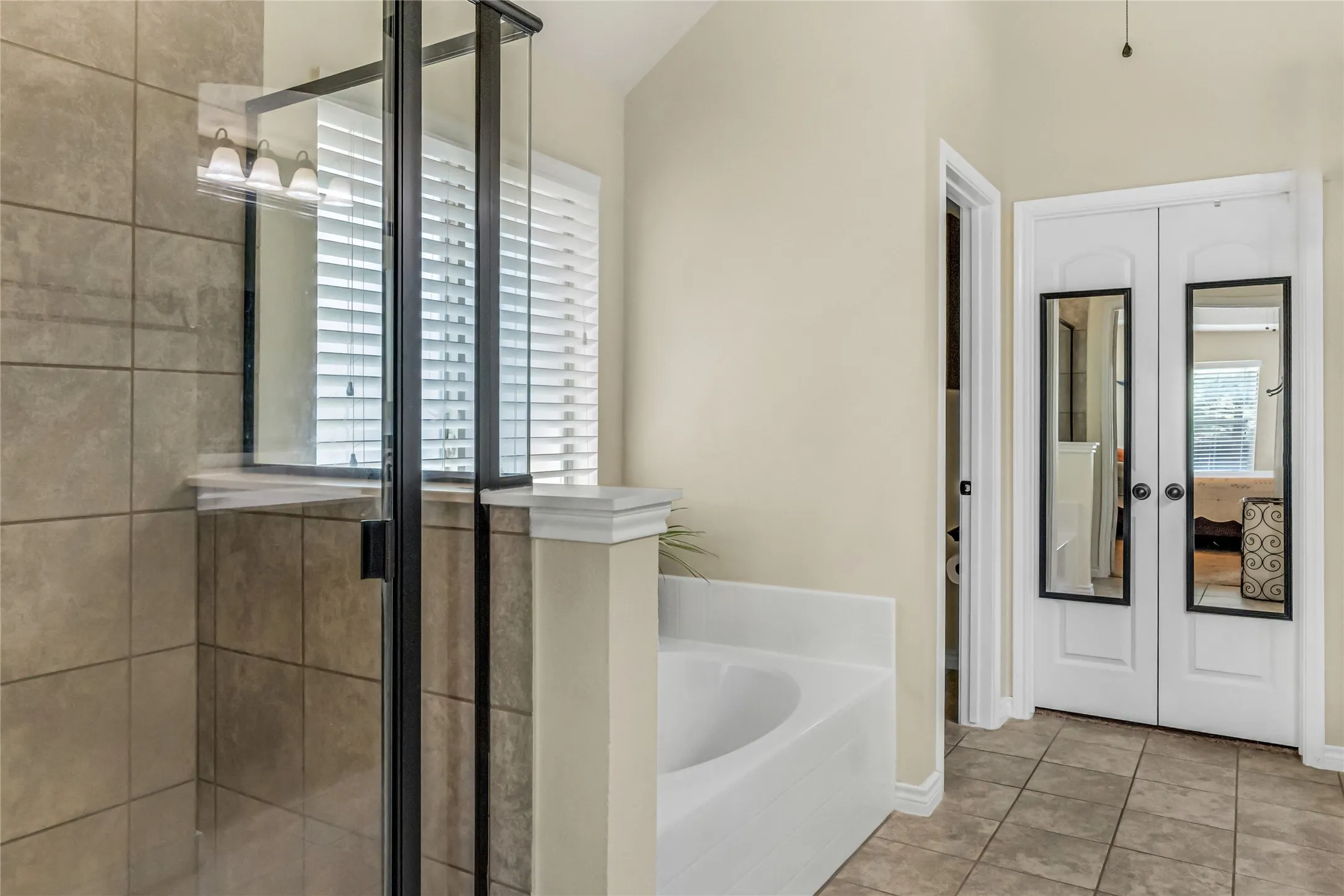Mirrored double doors lead to walk in closet