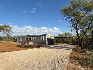 New, wide graveled driveway, covered parking