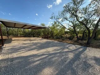 East side, wooded and heavy trees on all sides of property