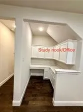Built-in desk with overhead cabinetry, recessed lighting, and wood-finish flooring