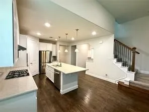 Kitchen featuring white cabinetry, stainless steel appliances, a center island with sink, and recessed lighting