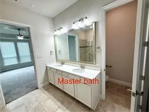 Dual vanity with integrated sinks, large mirror, and overhead lighting
