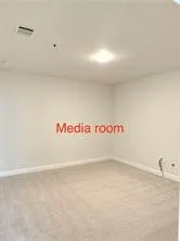 Neutral-toned carpeting and light-colored walls create a versatile interior