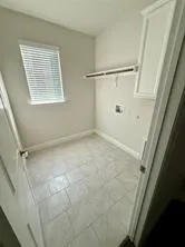 Tile flooring, built-in shelving, and upper cabinetry