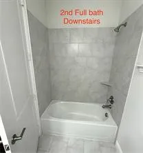 Bathtub with tile surround and shower fixture