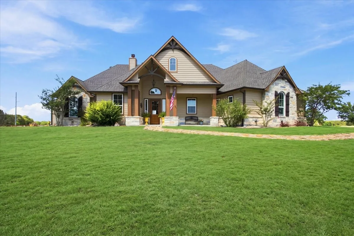 Stone and siding exterior with a covered porch