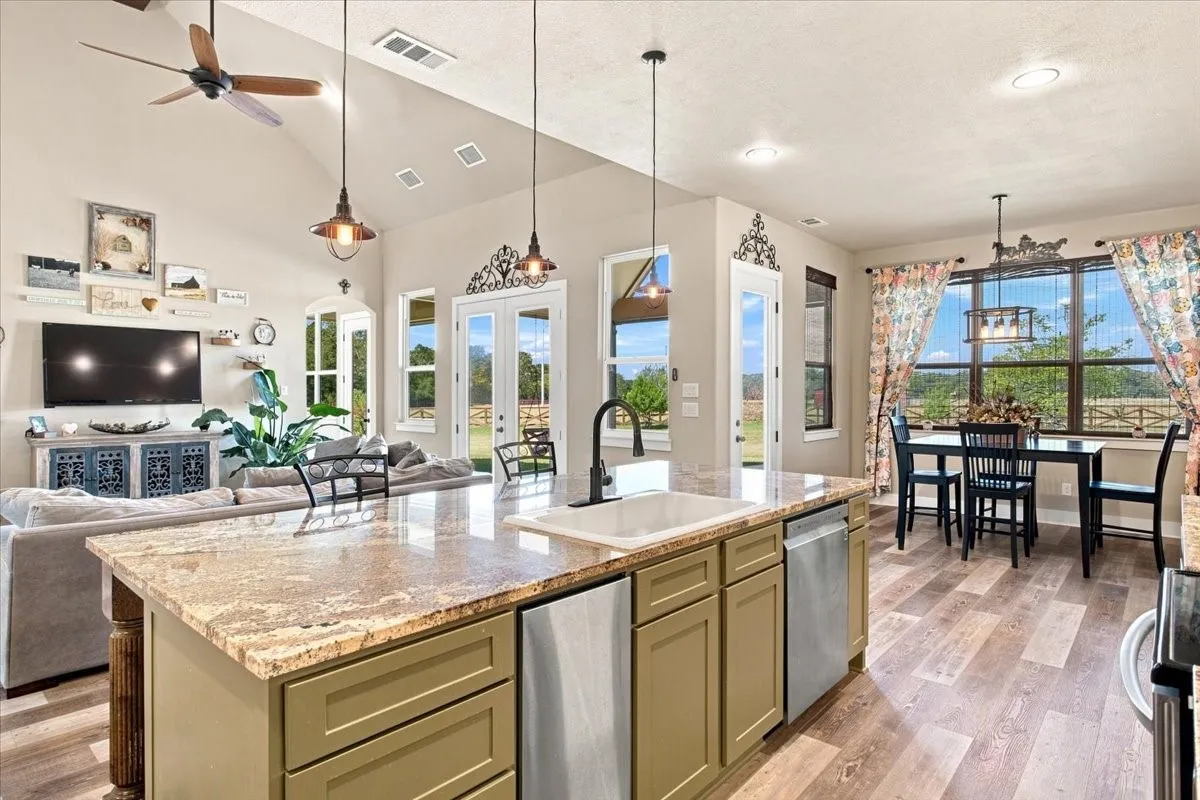 Kitchen island with a light-toned countertop, wood-finish flooring, and recessed lighting