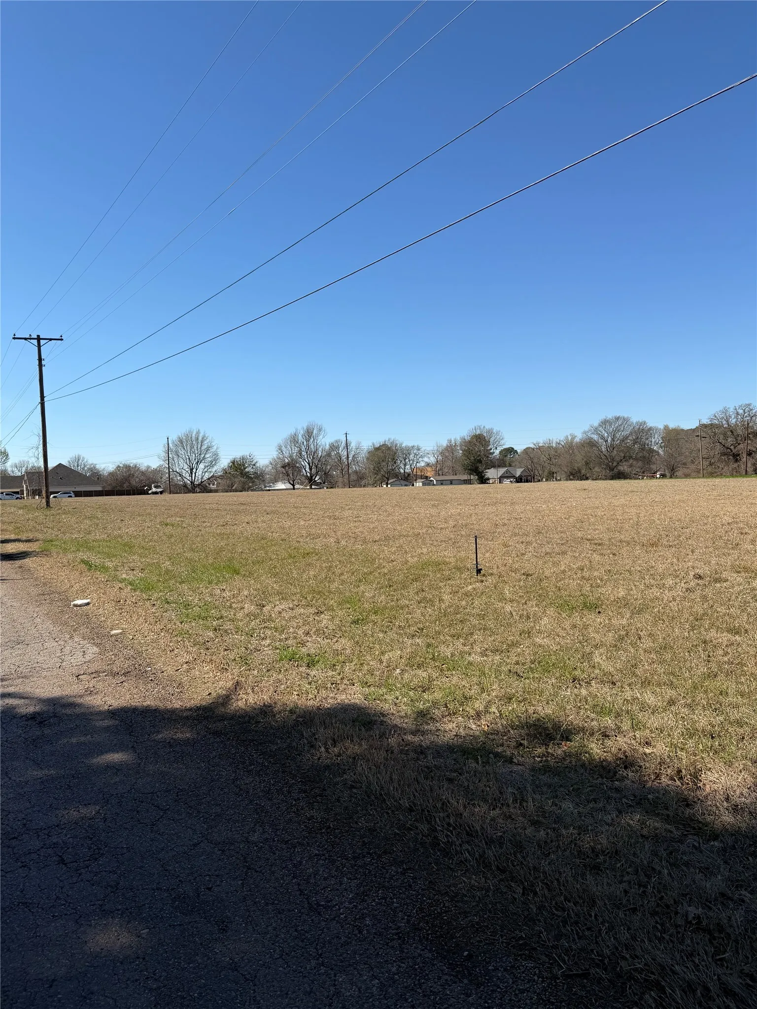 View of green lawn with a rural view