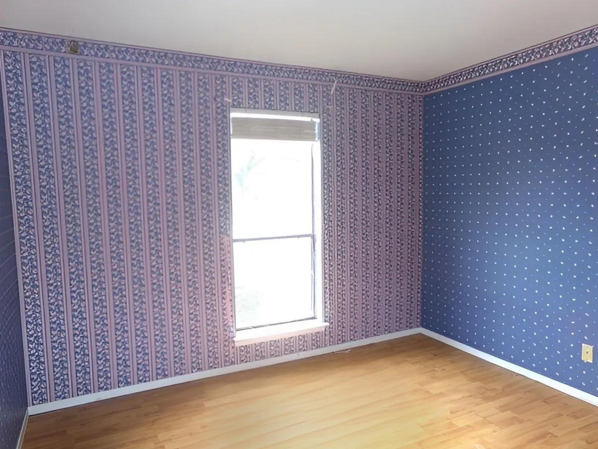 Wood-finish flooring with a window and wall-mounted electrical outlet