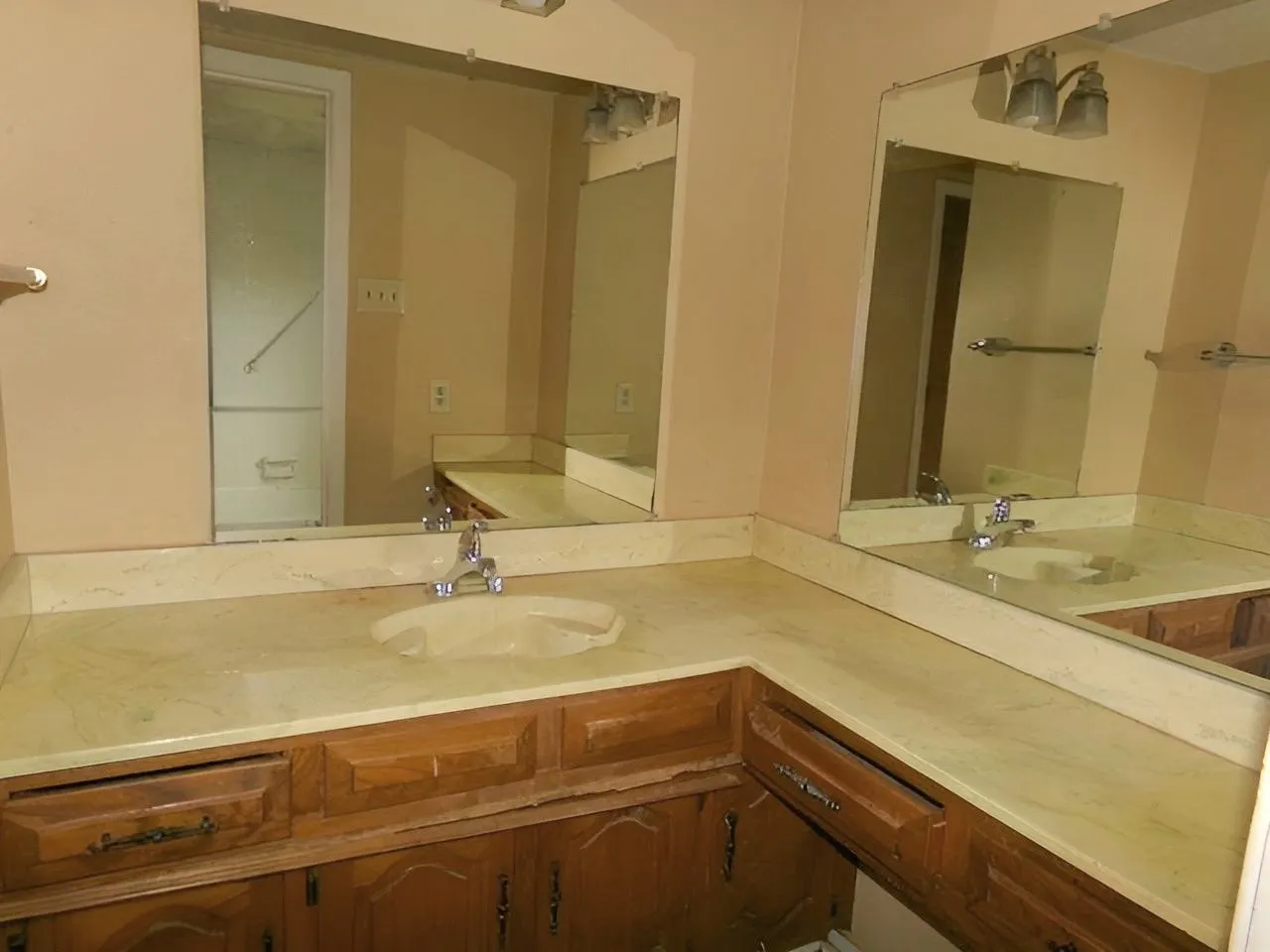 Dual vanity with light-toned countertops and integrated sinks