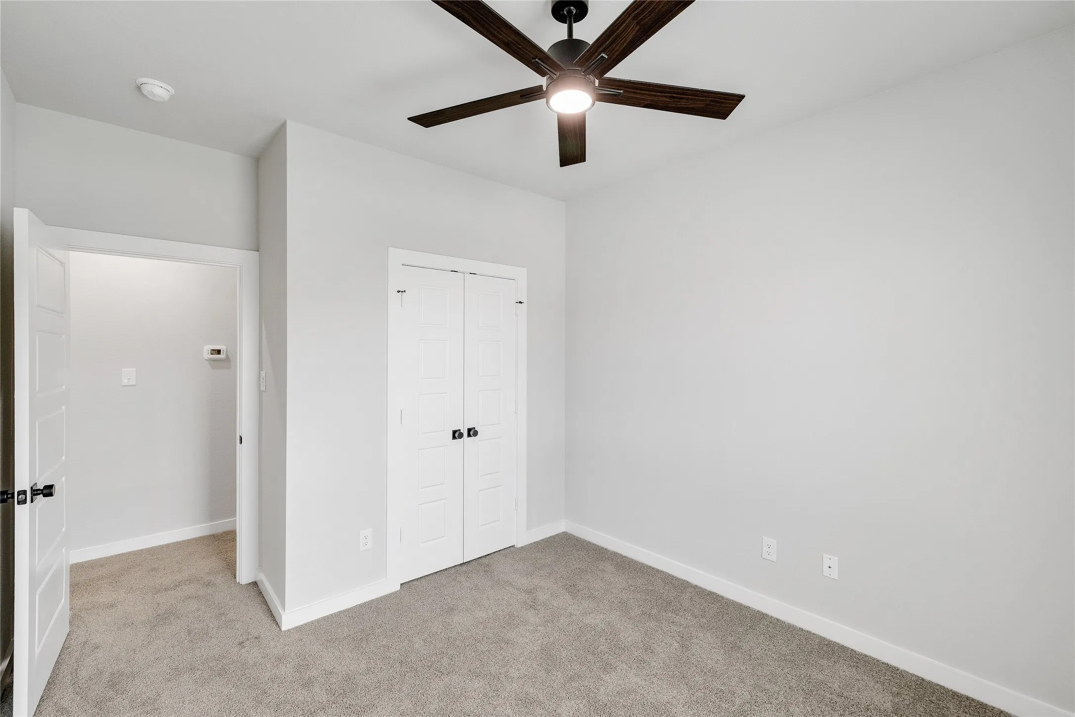 Recessed lighting, ceiling fan with integrated light, bi-fold closet doors, wall-to-wall carpeting, and white trim