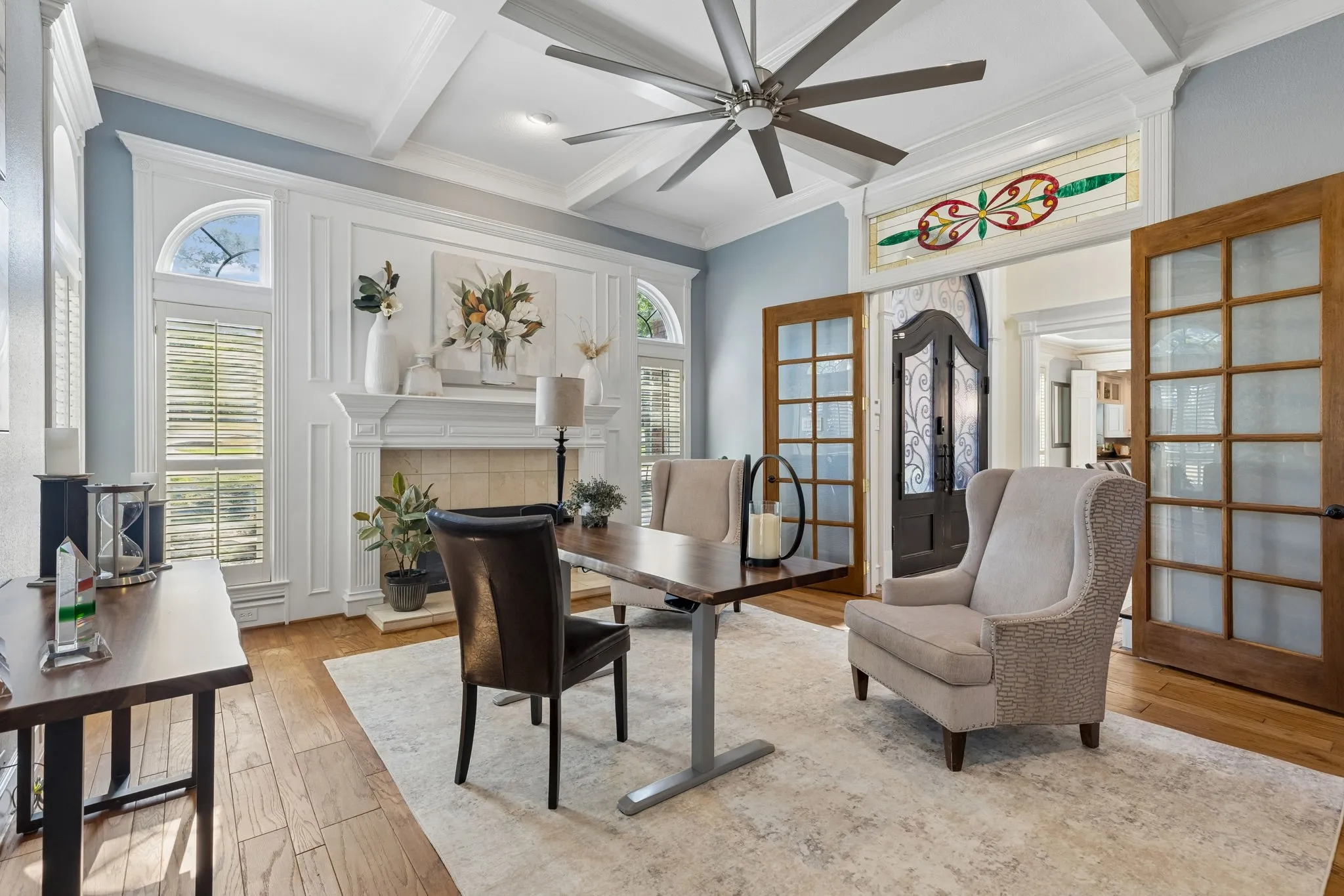 Front Living Room with coffered ceilings, fireplace and French doors is being used as a Study.