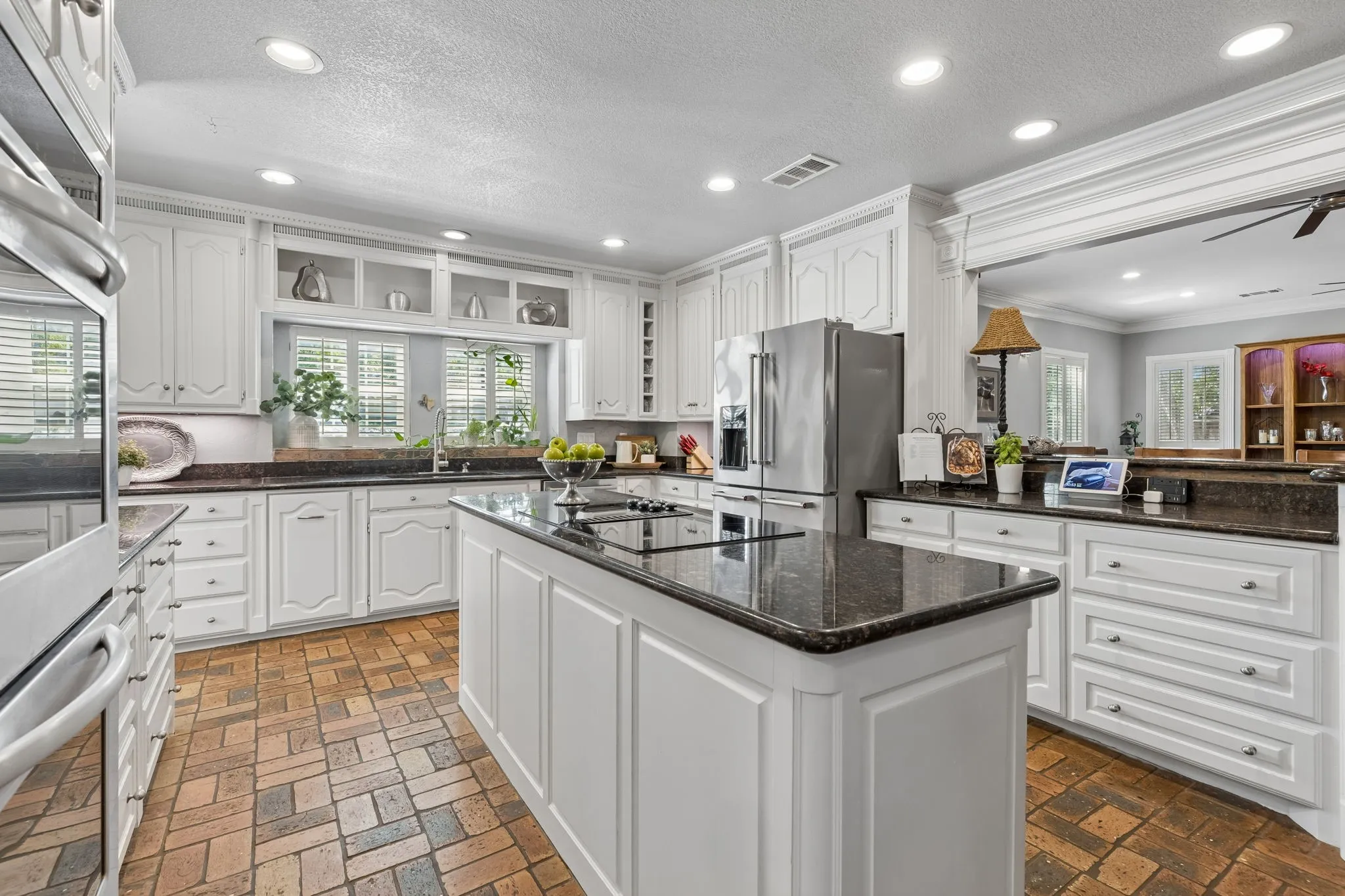 Double convection ovens, granite countertops and large picture window with plantation shutters.