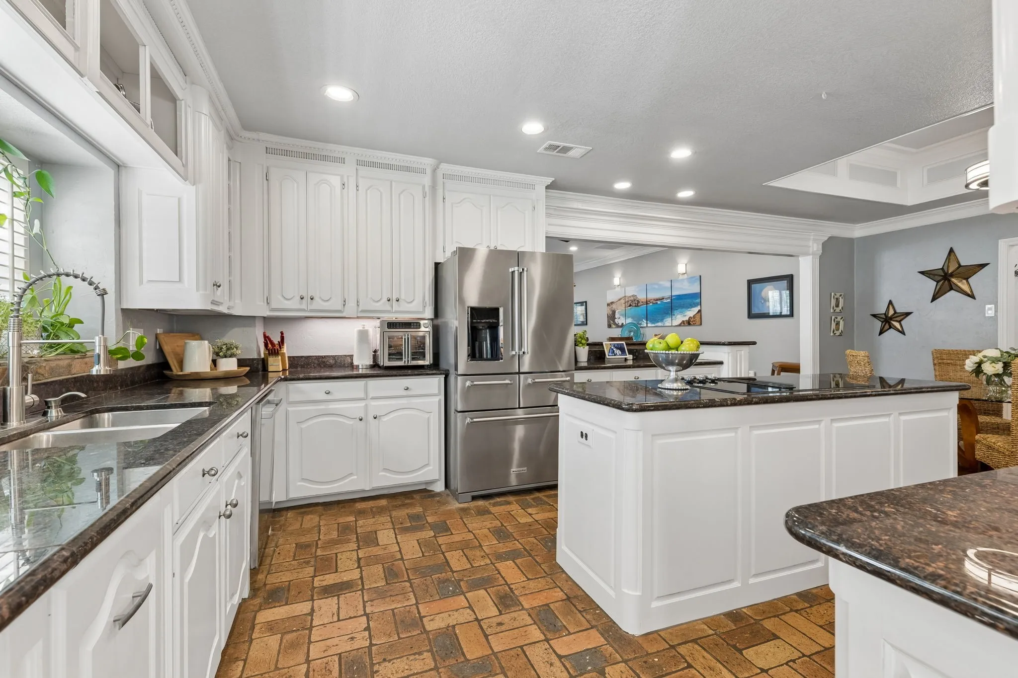 Updated kitchen with custom cabinetry, island and breakfast bar. Authentic Chicago Brick floors.