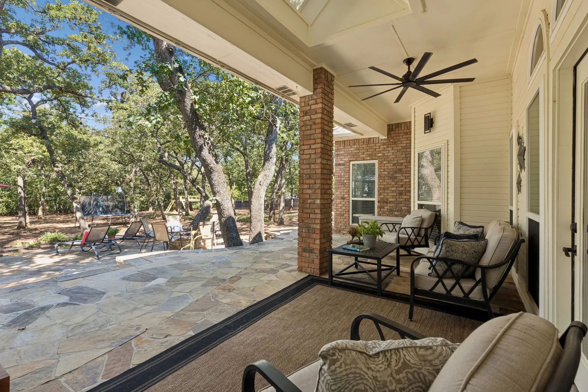 Covered back patio with ceiling fans and lighting.