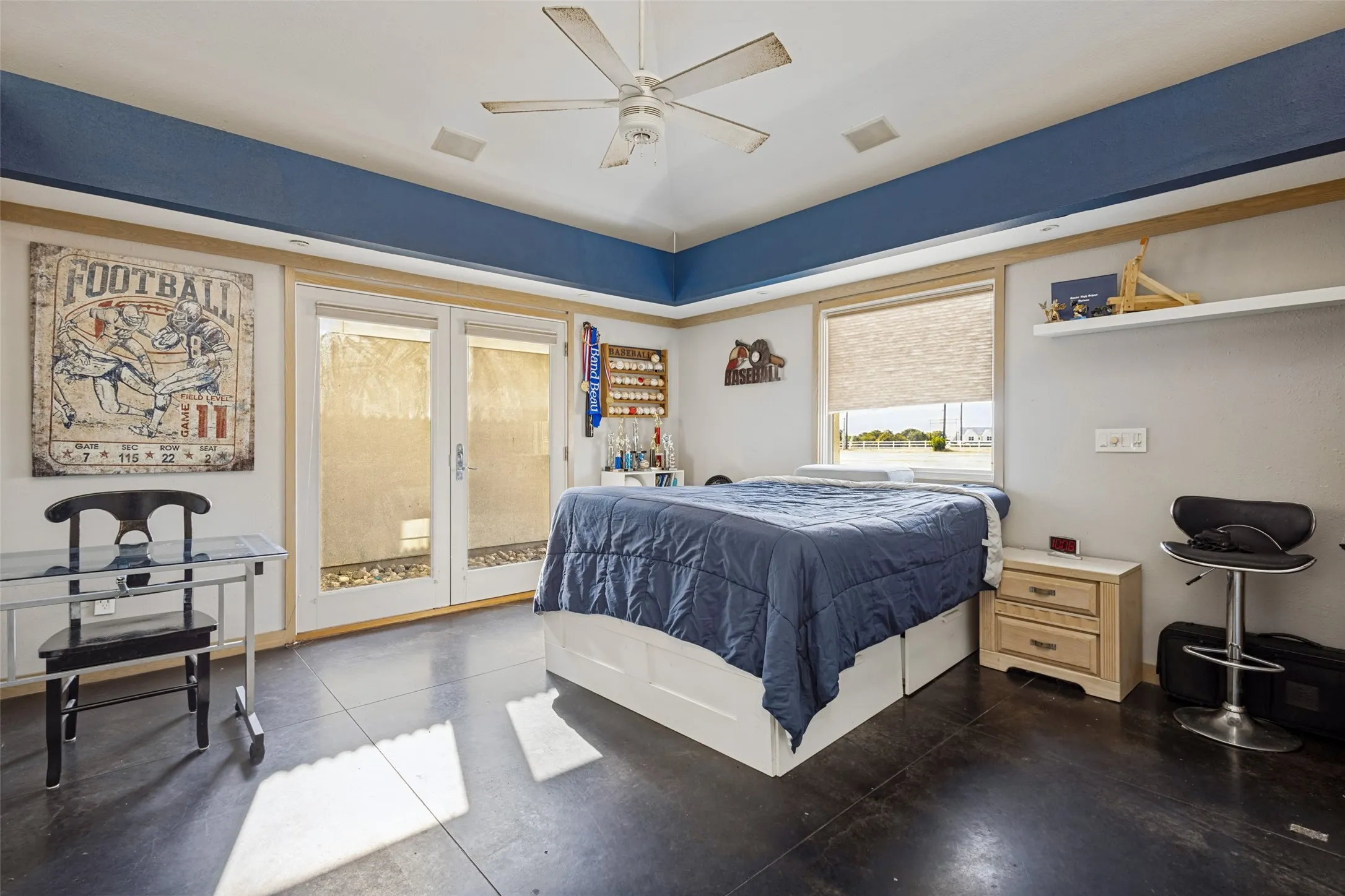 Both bedrooms have French doors with one operable door, and there is also a window in each room.  The side of the fur down in this bedroom is painted royal blue.