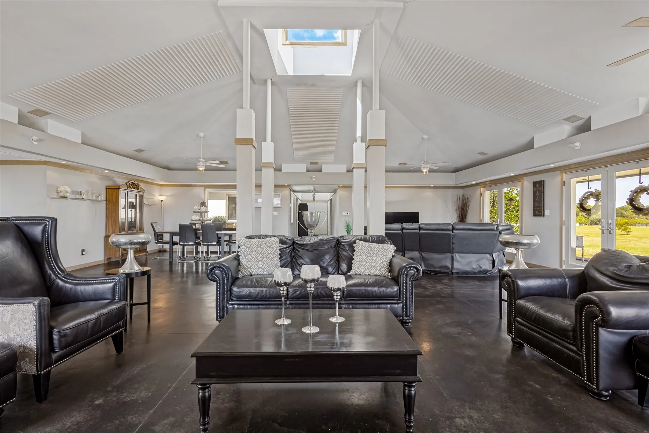 The design of the supports for the skylight at the center of the room help define and separate the four quadrants of the room.