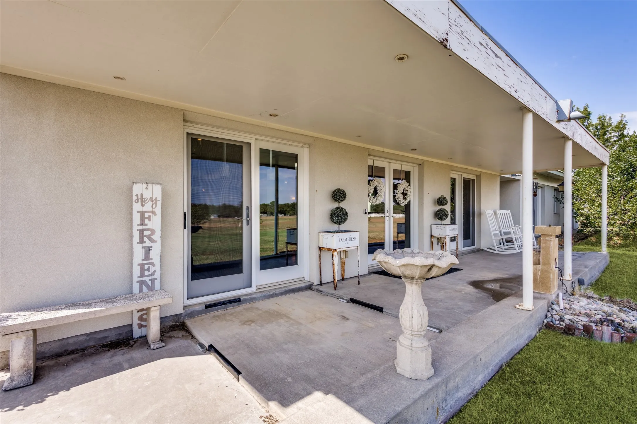 This charming front veranda has three sets of French style doors, with the middle set having two operational doors that open into the living area.  Bring the rockers or add a porch swing and enjoy relaxing moments out doors .
