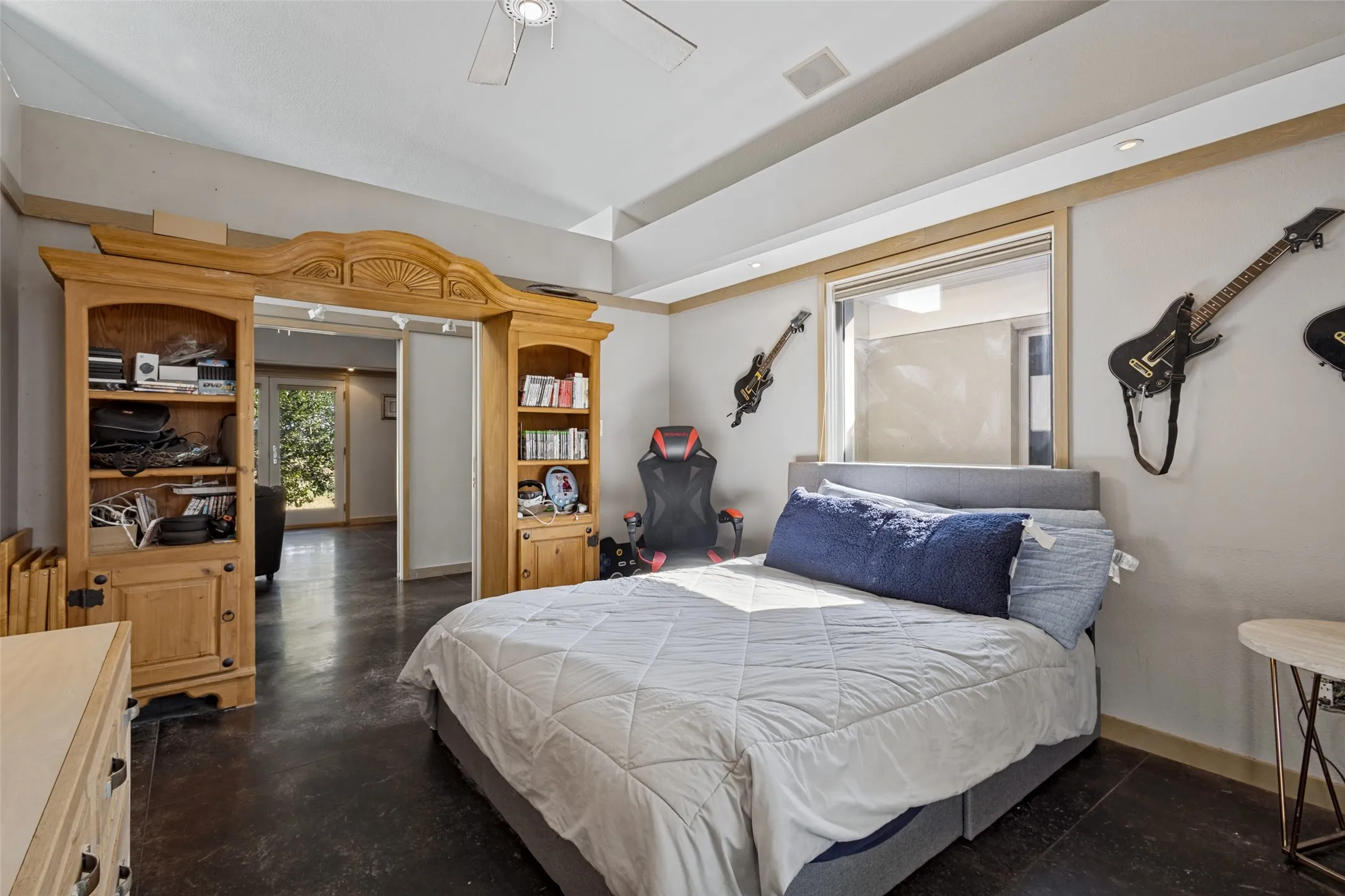 The floors in this room are stained concrete.  It has a window that allows light and a French door to the patio outside.