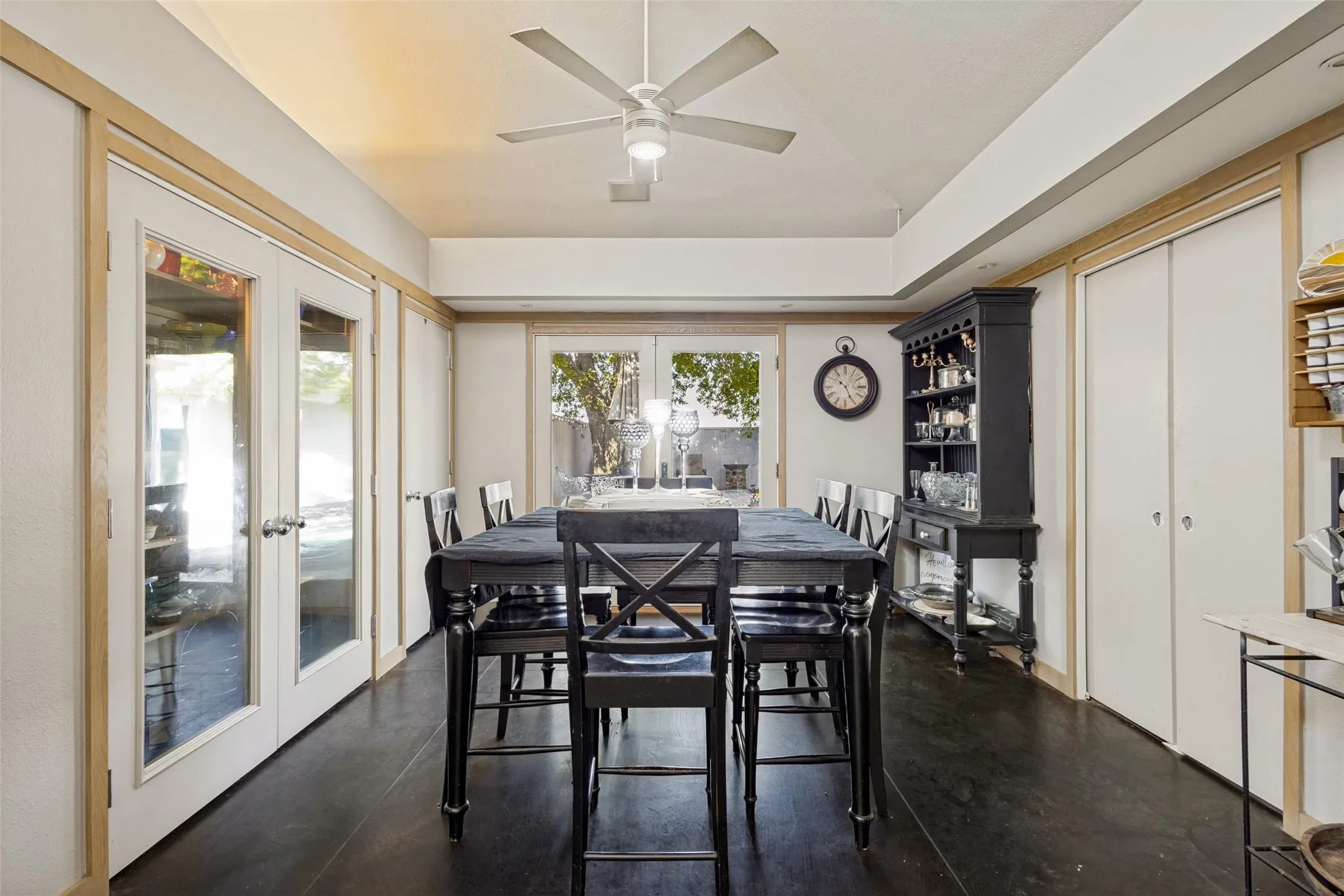This attractive dining area could be a formal or casual space depending on the family's needs.  Double pocket doors open to the utility room.  One set of French doors (with one operational and one stationary) allows light from the patio outside and another set opens to a storage space with shelving.  There are closets on either side.