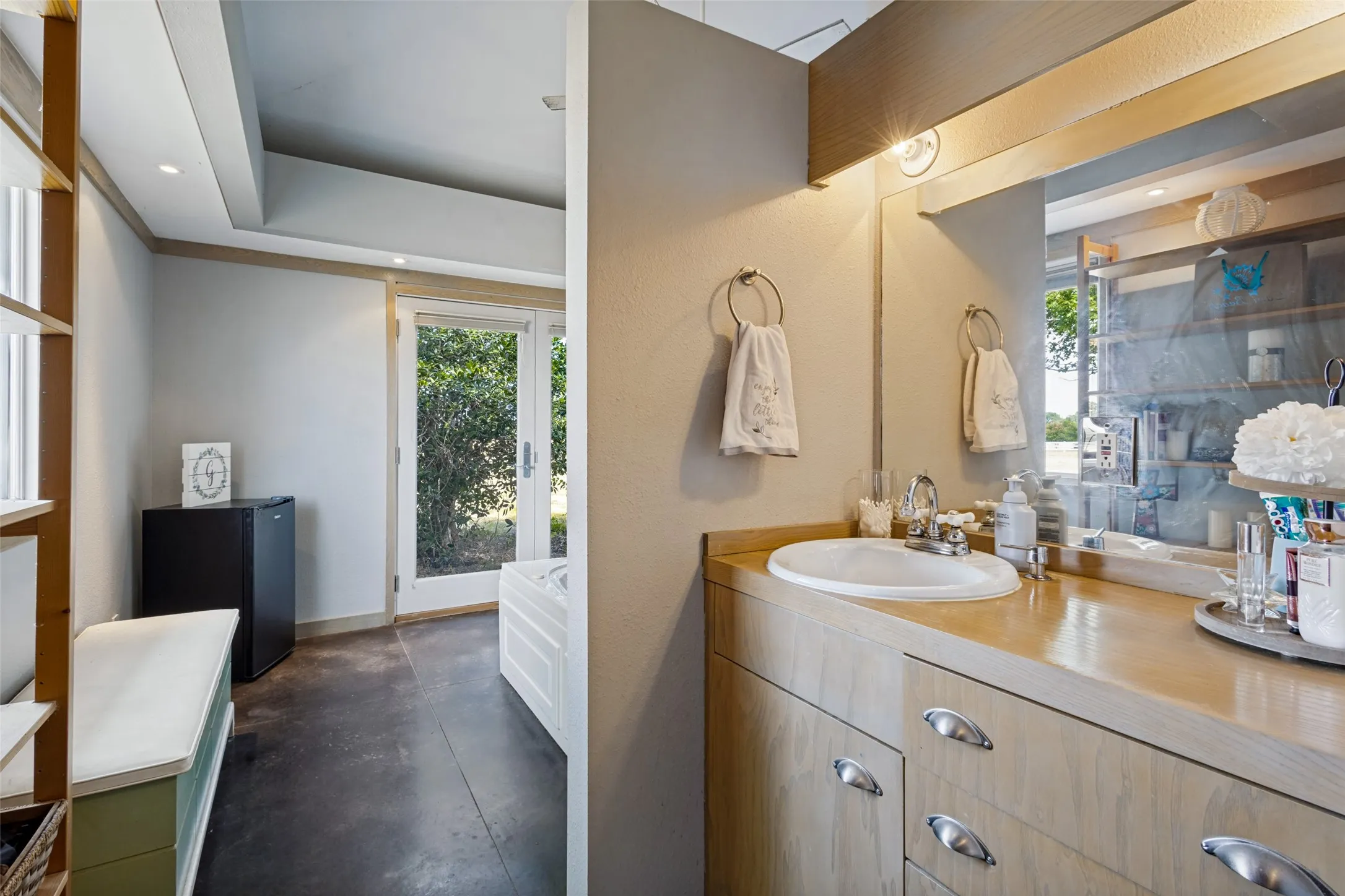 The second vanity area has a built-in vanity with a drop-in sink.  A wide mirror is above the vanity.