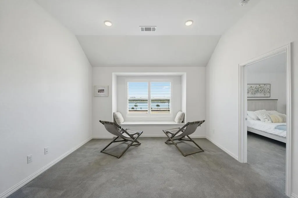 Recessed lighting, window seat, vaulted ceiling, and gray carpet flooring