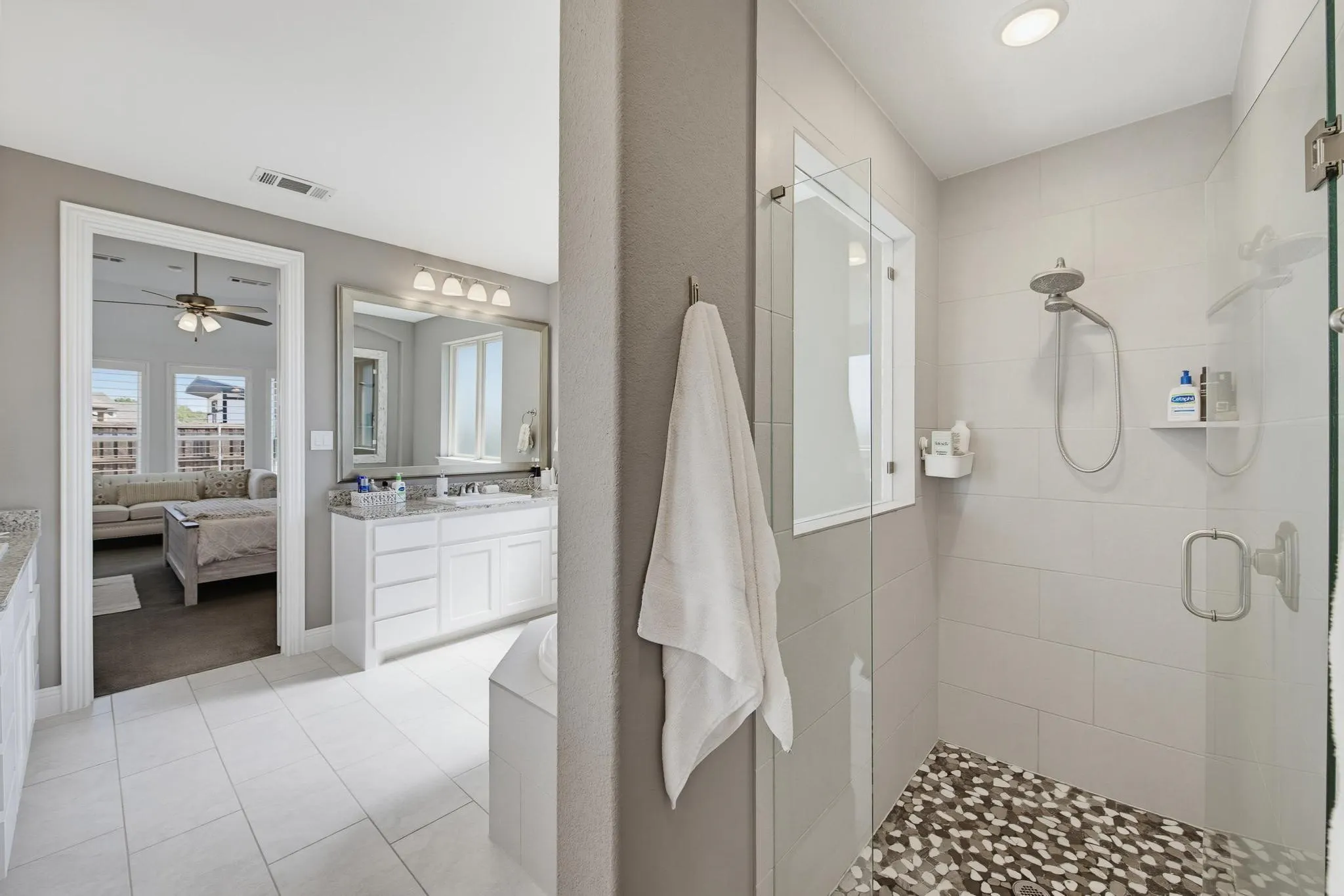 Walk-in shower with glass enclosure, integrated bench, and tiled walls