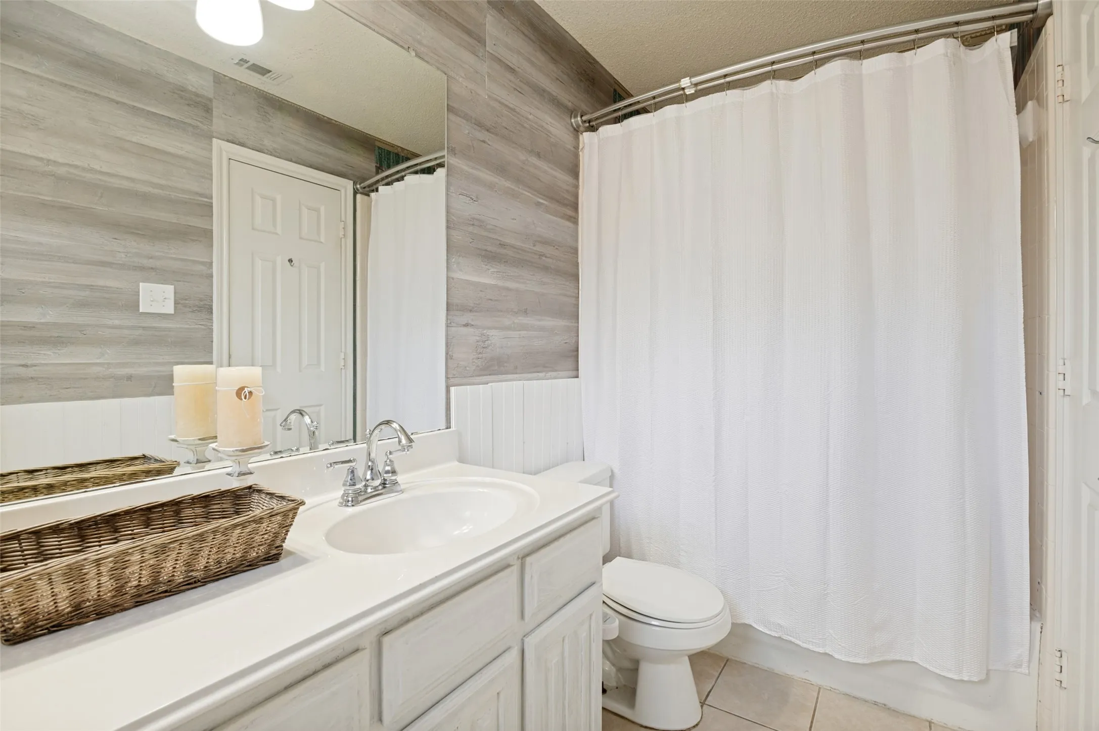 Vanity with an integrated sink, polished chrome faucet, and ample under-cabinet storage