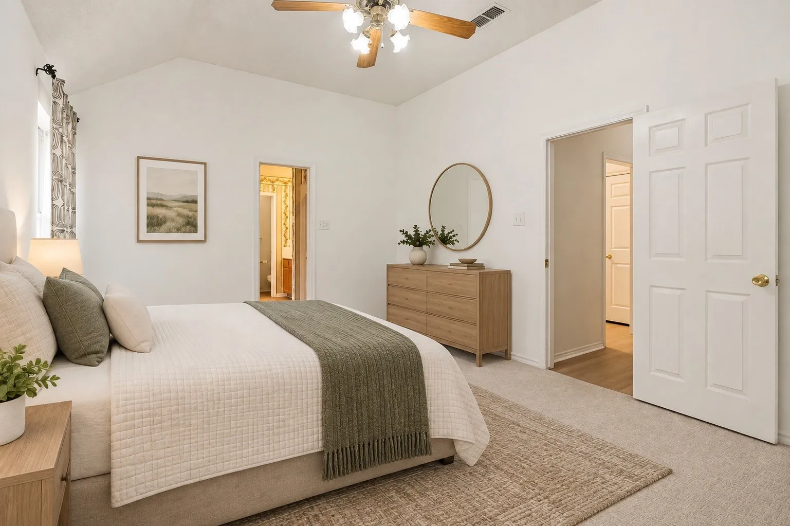 Vaulted ceiling featuring a ceiling fan, carpeted flooring, and a six-panel interior door