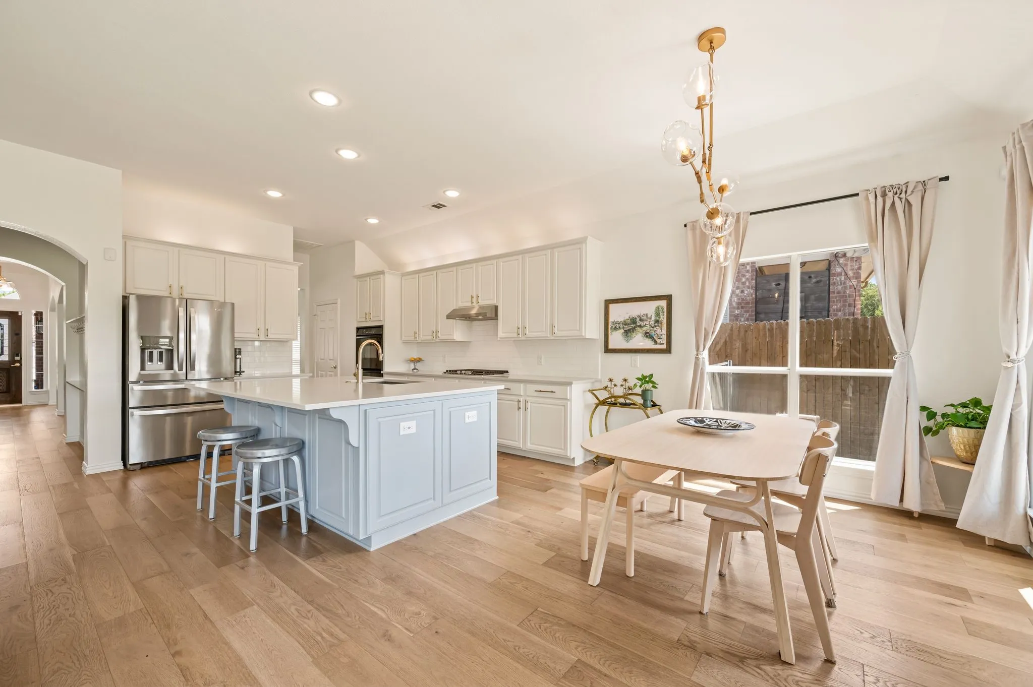 Spacious eat-in breakfast area with one of several gorgeous light fixtures throughout the home.