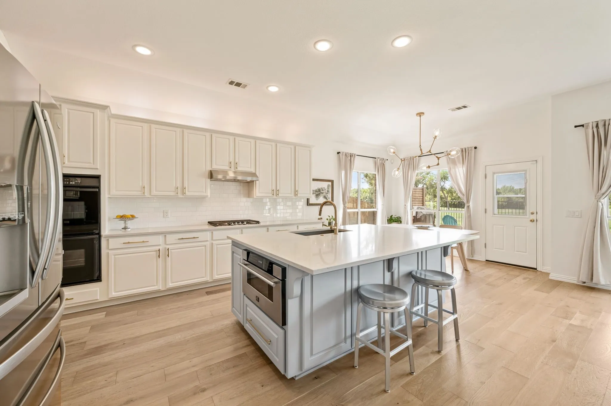 This kitchen is dreamy! Also, notice the upscale microwave drawer tucked into the oversized island.