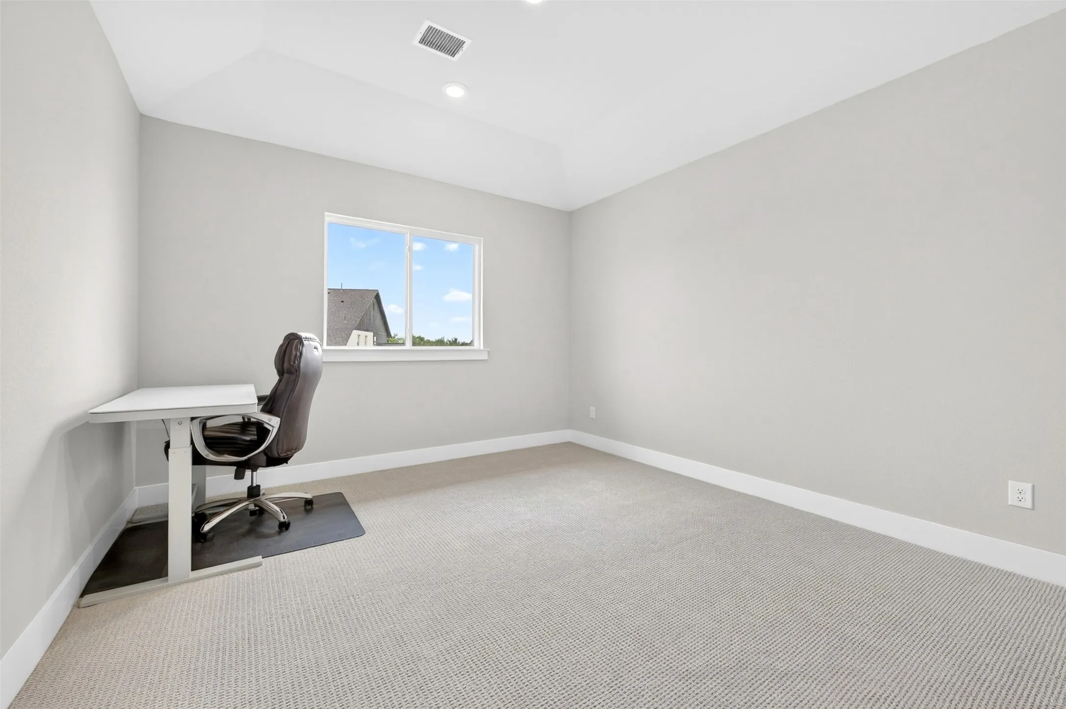 Recessed lighting, light gray wall finish, white window trim, carpeted flooring, and white baseboards